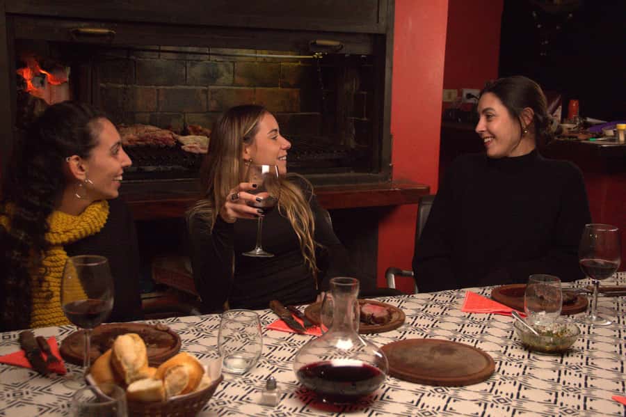Secrets of Asado in Buenos Asado, BBQ and Dinner - Where the fire starts: patio grill, white wine, and asado rhythm